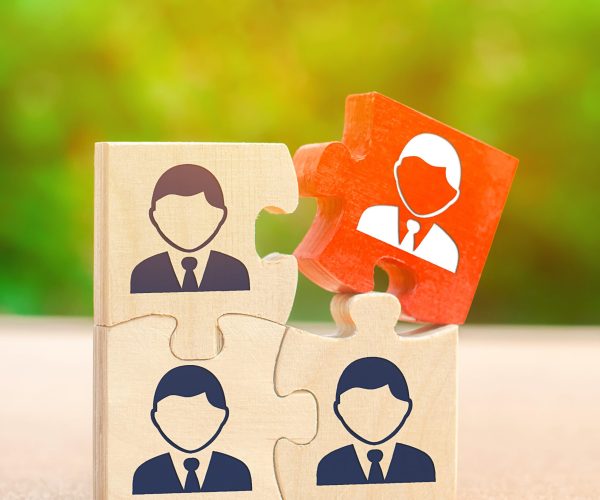 Wooden puzzles with the image of workers. The concept of personnel management in the company. Dismissing an employees from a team. Demotion. Bad worker. Staff cuts. Human resources. Hiring, hire